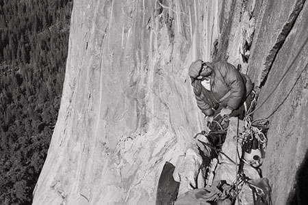 photo of climber on a big wall belaying