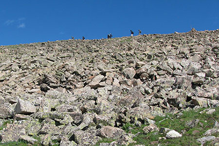 hikers on the ridge of scree