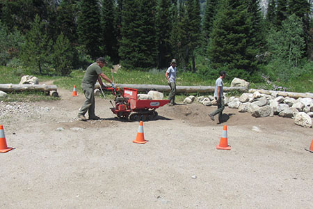 trail crew moving rocks