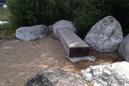 Bench on the shore among rocks