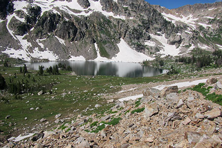 Lake Solitude sits below cliffs