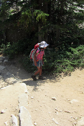 Child hiking in the heat of the sunny Tetons.