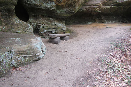 a bench under a rockhouse